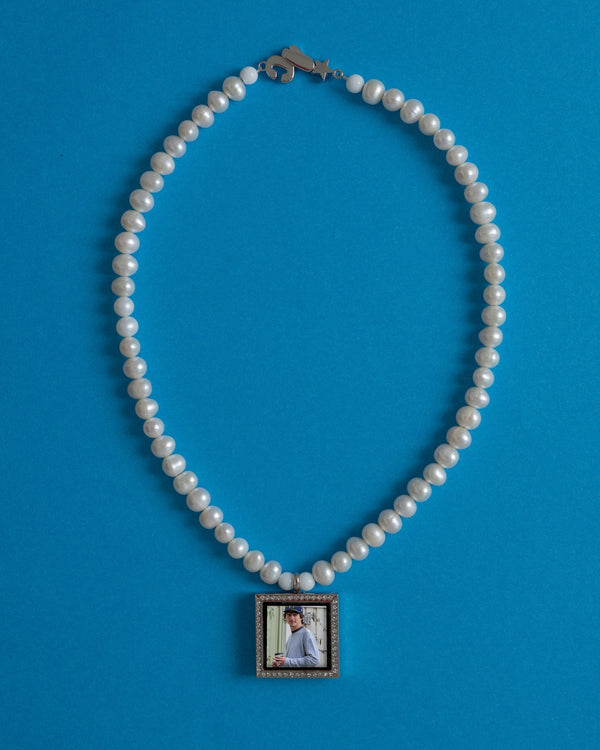 Freshwater pearl necklace with a square photo-frame pendant on a blue background – custom pendant necklace