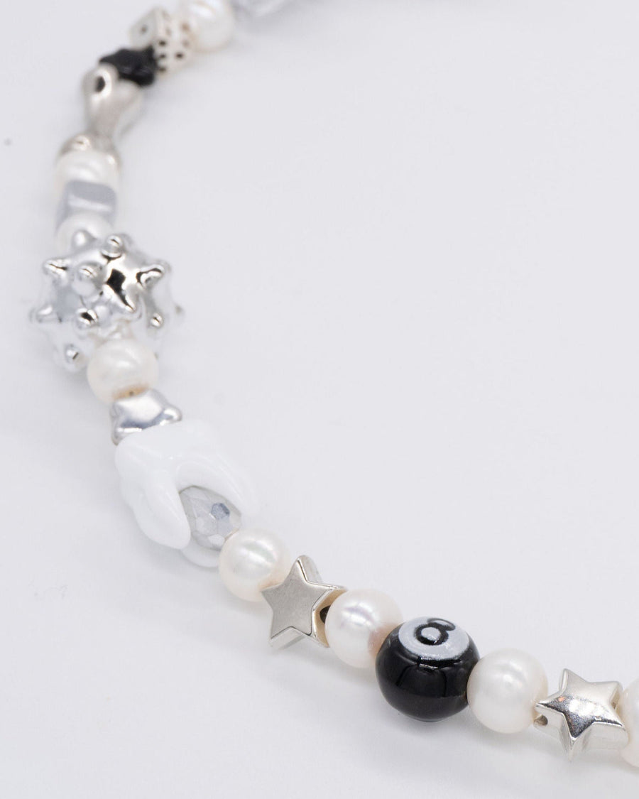 Macro of a silver spiky bead and freshwater pearls on the sloane necklace