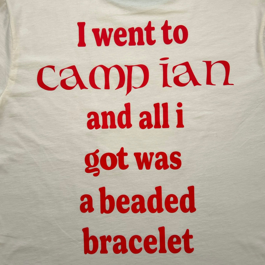 Close-up of red camp ian slogan print on the back of a cream ringer tee