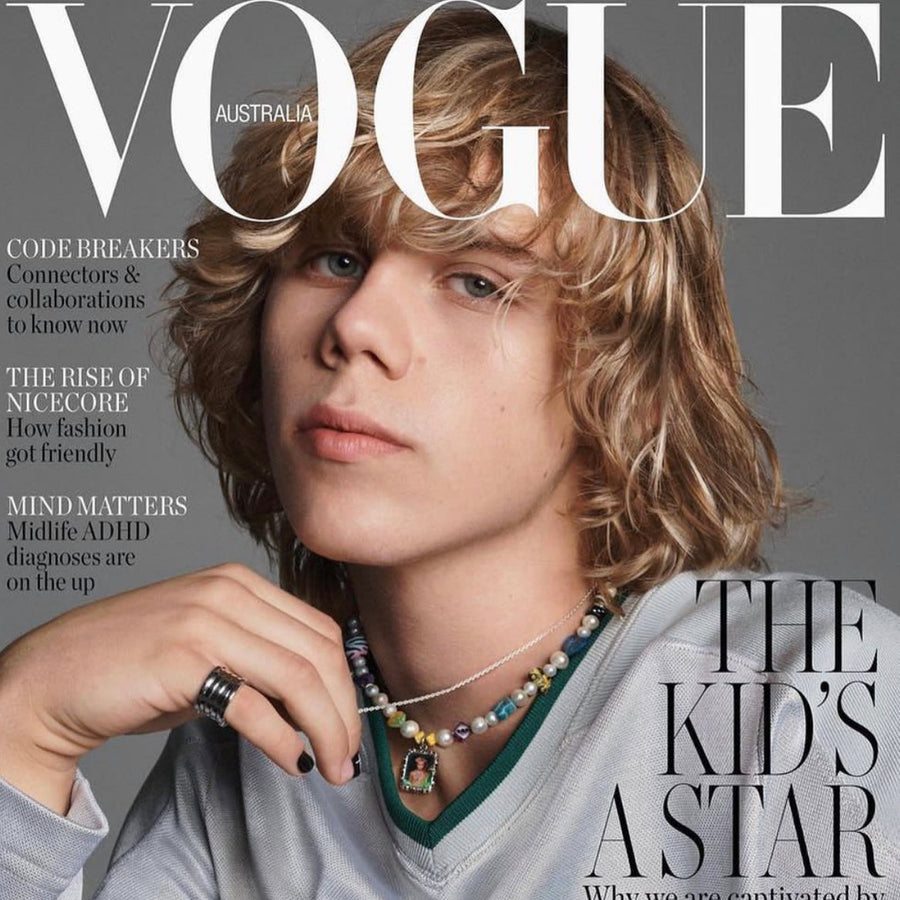 Magazine cover of a young man wearing a custom beaded charm necklace