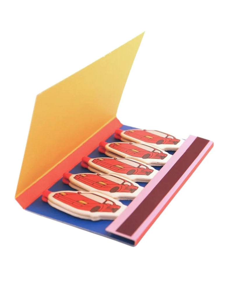 Open matchbook with red sports car shaped matches on a yellow cover – michaels matchbook by Ian Charms