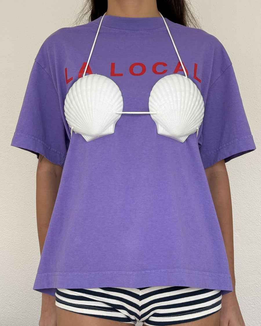 Purple LA LOCAL tee styled with a white seashell bikini top and striped shorts
