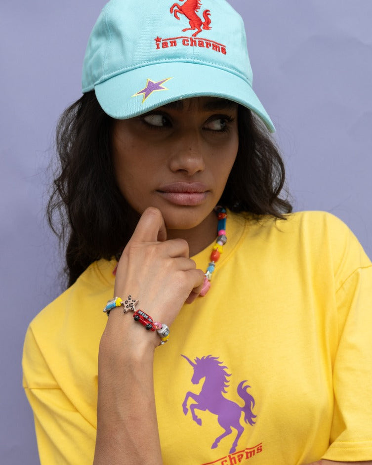 Woman in a light blue cap and yellow pony soprano tee wearing the colorful LA bracelet