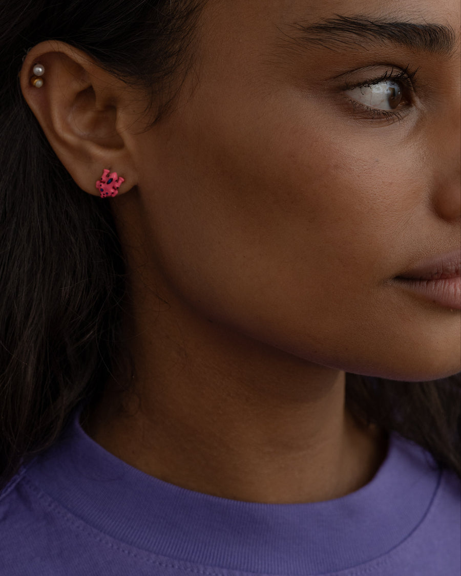 Woman in a purple tee wearing a pink frog stud earring – the not your prince (yet!!) studs