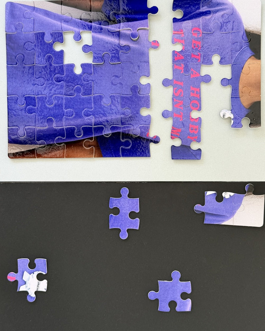 Collage of a half-finished jigsaw puzzle of the get a hobby tee with loose purple pieces