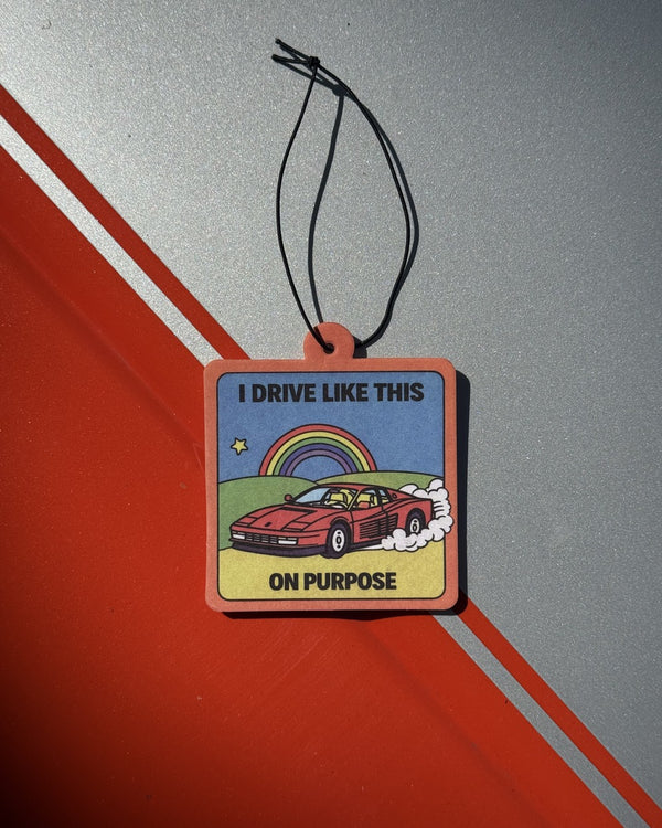 Car air freshener reading I DRIVE LIKE THIS ON PURPOSE with a red sports car and rainbow – worst driver car air freshener