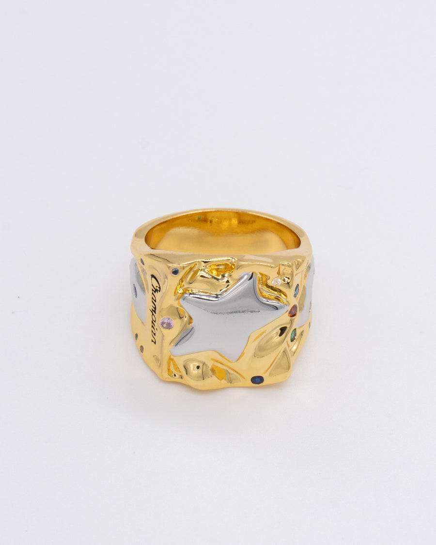 Gold championship-style ring with a raised silver star and small colored gems – the champian ring in gold