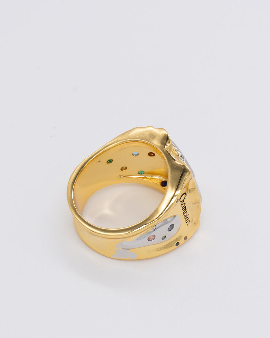 Side view of the gold champian ring showing engraved script and inset colored gems