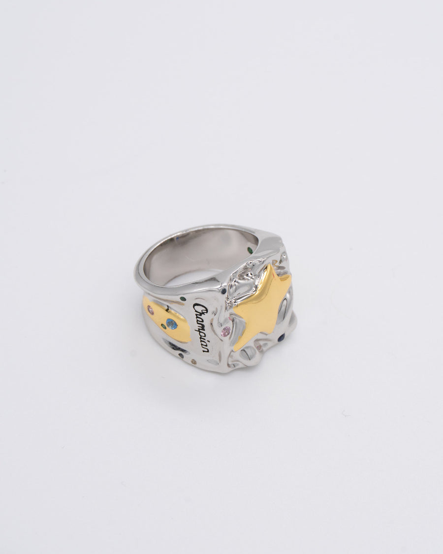 Side view of the silver champian ring showing engraved script and a gold star accent