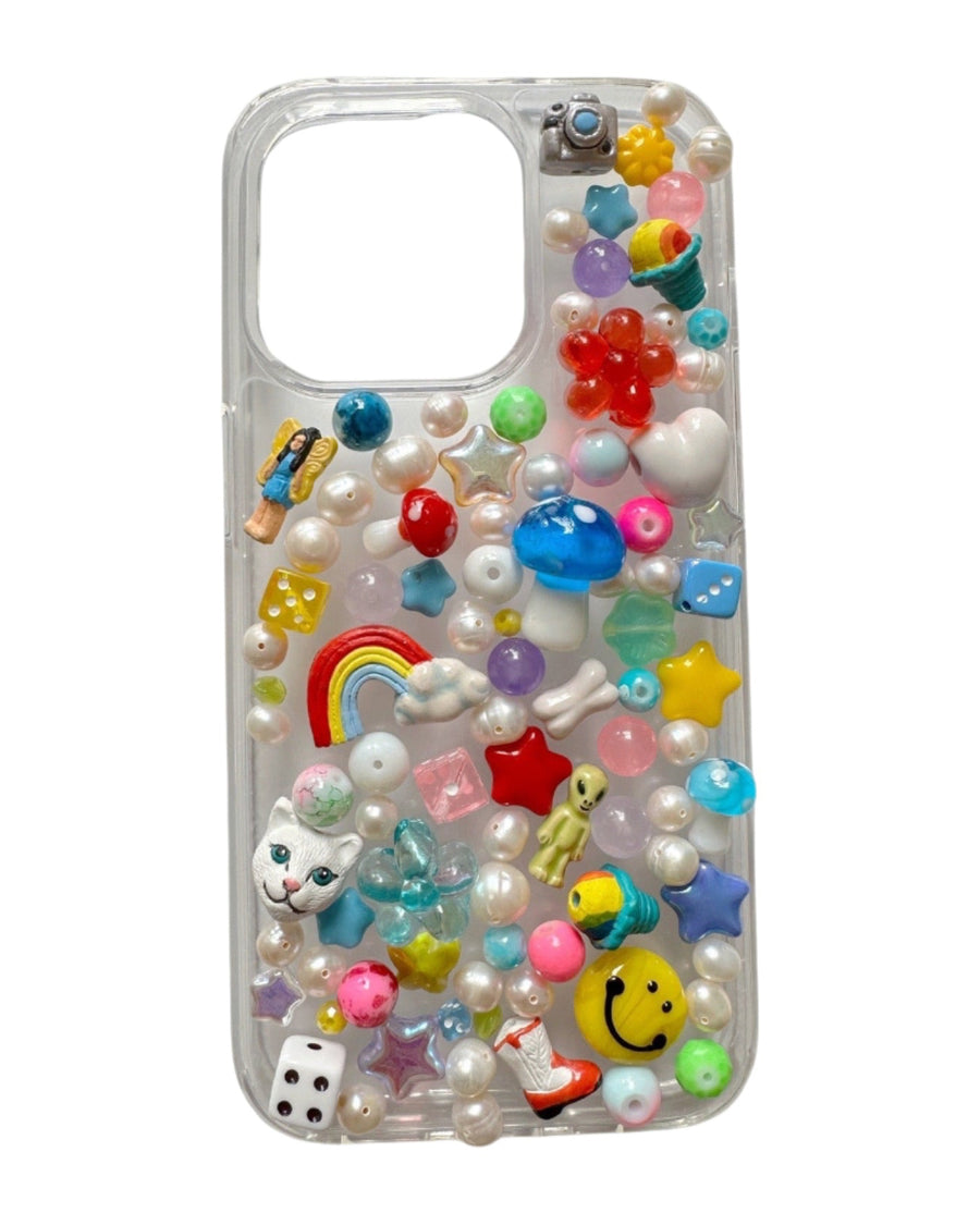 Clear iPhone case covered in pearls, rainbow, smiley, dice, star and heart charms – the lisa phone case by Ian Charms