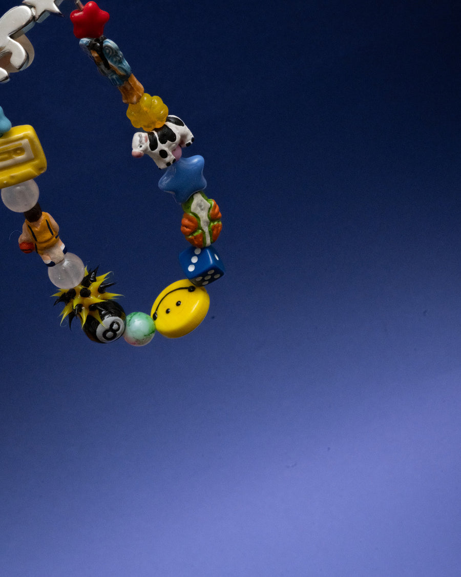 The perfect bracelet does not exi.. with colorful novelty beads against a dark blue background