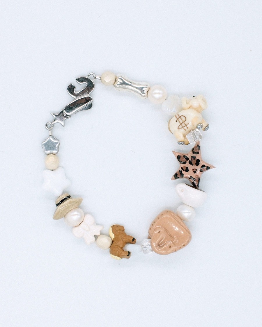 Quiet lux bracelet with leopard star, horse, dog, pearl and cream flower beads on white