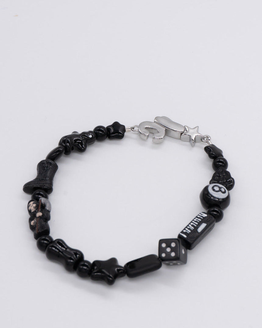 Black beaded bracelet with 8-ball, dice, star and bone beads and a silver clasp – the smoker bracelet by Ian Charms